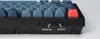 A close-up view of the side of a black and gray keyboard, showing connection ports and switches. Produktbild-Vorschau