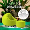 A lime green beanbag chair and ottoman are shown in a lush, tropical setting with large green leaves and a zebra-striped rug. Anteprima dell’immagine prodotto
