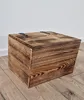 A wooden chest with a lid sits on a wooden floor against a white wall. Produktbild-Vorschau