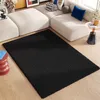 A black shaggy rug is placed on a wooden floor in front of a modular white sofa in a living room setting. Anteprima dell’immagine prodotto