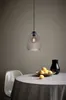 A pendant light hangs above a dining table set with a tablecloth, a bowl of lemons, and a black vase. Anteprima dell’immagine prodotto