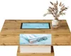 A modern wooden coffee table with a built-in LED light and decorative elements. Produktbild-Vorschau