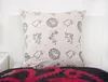 A close-up shot of a pillow with a Game of Thrones pattern, placed on a bed with a red and black blanket. Produktbild-Vorschau
