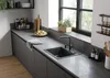 A modern kitchen counter with a sink, faucet, and various kitchen accessories. Anteprima dell’immagine prodotto