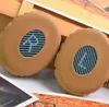 Two ear pads for headphones are shown in a close-up shot, resting on a surface with other items. Produktbild-Vorschau
