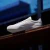 A white Adidas sneaker is displayed on a wooden shelf against a dark, blue-lit background. Produktbild-Vorschau