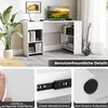 A modern white L-shaped desk with shelves and a drawer, set up in a home office environment with a plant, computer, and guitar. Podgląd zdjęcia produktu