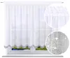 A white sheer curtain with a decorative border is shown hanging on a window. Produktbild-Vorschau