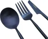 A set of black cutlery including a spoon, fork, and knife, arranged diagonally on a white background. Voir les images du produit