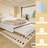 A white daybed with a pull-out trundle bed is shown in a bedroom setting, with decorative elements on the right side of the image. Podgląd zdjęcia produktu
