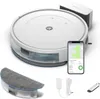 A white robot vacuum cleaner with its accessories and a smartphone displaying its app. Náhľad obrázku produktu