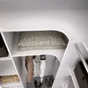 Interior view of a white closet with shelves and hanging clothes. Produktbild-Vorschau