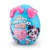A blue egg-shaped toy with pink ears and a unicorn horn, featuring a cartoon puppy on the front. Anteprima dell’immagine prodotto