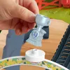 A hand holding a toy trophy with a train design on it, part of a toy train set. Náhľad obrázku produktu