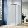 A modern bathroom with a curved glass shower enclosure. Produktbild-Vorschau