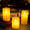 Three LED candles are arranged on top of books, with a blurred background. Podgląd zdjęcia produktu