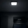 A ceiling light fixture illuminates a dark garage with storage cabinets. Náhľad obrázku produktu