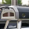 Close-up of a black and silver pizza oven with a thermometer. Produktbild-Vorschau