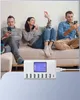 Three people sitting on a couch, each using a smartphone. A white USB charging station is placed in front of them. Produktbild-Vorschau