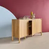 A wooden sideboard is placed in front of a wall with a maroon and light blue abstract design. Produktbild-Vorschau