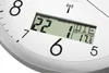 A close-up of a digital clock face showing the date, month, and temperature. Produktbild-Vorschau