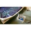 A pump connected via hoses to a large blue air mattress on a table. Anteprima dell’immagine prodotto