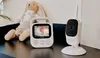A baby monitor set, including a parent unit with a screen displaying a baby, and a camera unit, is placed on a dark surface next to a stuffed toy. Anteprima dell’immagine prodotto