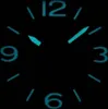 A close-up view of a watch face in the dark, with luminous hands and numbers. Anteprima dell’immagine prodotto