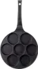 A top-down view of a black pancake pan with seven circular indentations and a black handle, set against a white background. Náhled obrázku produktu