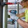 A construction worker is using a Bosch impact driver to install something on a door frame. Produktbild-Vorschau