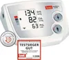 A white digital blood pressure monitor with a display showing readings and buttons for user selection, along with certification seals. Produktbild-Vorschau