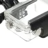 A close-up view of a clear plastic waterproof housing with silver clasps, likely for an action camera. Produktbild-Vorschau