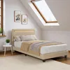 A bedroom with a bed, a skylight, and artwork on the wall. Náhled obrázku produktu