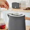 A hand is adding something to a kettle in a kitchen setting. Produktbild-Vorschau
