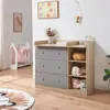 A nursery room with a changing table, a small clothing rack, and a rug. Produktbild-Vorschau