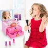 A young girl in a red dress is playing with a toy makeup set. Produktbild-Vorschau