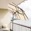 A balcony with a view of the ocean and a beach, featuring a beige umbrella. Anteprima dell’immagine prodotto