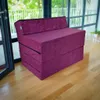 A purple foldable mattress/sofa is displayed in a room with large windows and wooden flooring. Podgląd zdjęcia produktu