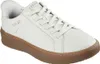 A white Skechers sneaker with a brown sole is shown from a side angle against a white background. Voir les images du produit