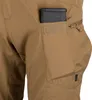 Close-up of the side pocket of tan tactical pants with a magazine inserted into a smaller utility pouch. Produktbild-Vorschau