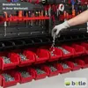A person's hand wearing a glove is pouring screws into red storage bins that are part of a wall-mounted storage system in a workshop. Anteprima dell’immagine prodotto