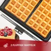 A close-up of a waffle maker with two golden-brown waffles inside, accompanied by a small pile of raspberries and blueberries on a waffle. Text overlays highlight product features. Produktbild-Vorschau