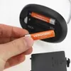 A hand is inserting batteries into a device. Produktbild-Vorschau