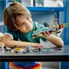 A young boy is playing with a LEGO space exploration set on a table. Produktbild-Vorschau