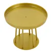 A gold-colored round stand with legs, isolated on a white background. Podgląd zdjęcia produktu