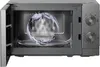 An open microwave with water splashing inside, demonstrating a cleaning feature. Anteprima dell’immagine prodotto