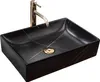 A black rectangular vessel sink with gold veining and a gold faucet, shown against a white background. Produktbild-Vorschau