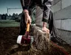 A construction worker is using a sledgehammer to adjust a stone block on a building site. Náhľad obrázku produktu