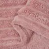 A close-up view of a pink fleece throw blanket, showing its textured surface and folded edges. Náhľad obrázku produktu