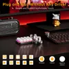 A close-up view of a white mechanical keyboard with RGB lighting and several silver rotary knobs, placed on a black desk. The background features a blurred image of a computer monitor with red lighting effects and a small yellow figurine. Produktbild-Vorschau